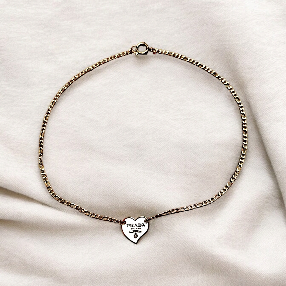 White heart emblem on a stainless steel necklace